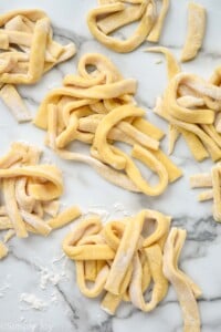 overhead of piles of raw egg noodles