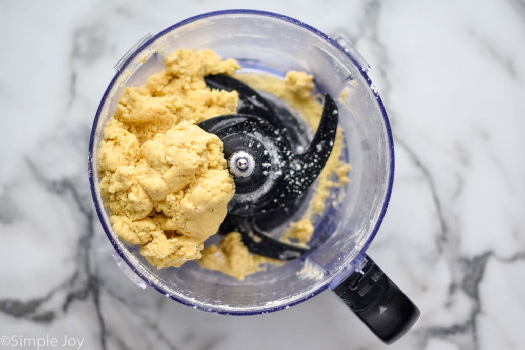 overhead of egg noodle dough in a food processor