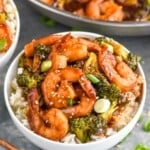 Overhead photo of shrimp and broccoli stir fry in a white bowl served over rice. - 8