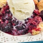 Pinterest graphic of Blackberry Cobbler. Image is overhead photo of blackberry cobbler garnished with a scoop of ice cream. Text says, "Amazing Blackberry Cobbler simplejoy.com"