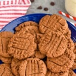 Pinterest graphic of Chocolate Peanut Butter Cookies Recipe. Text says, "Amazing chocolate peanut butter cookies." Image is an overhead photo of a plate of chocolate peanut butter cookies.