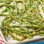 Pinterest graphic for italian green beans recipe. Image is overhead photo of italian green beans on a baking sheet. Text says, "tried and tested italian green beans simplejoy.com"