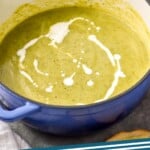 Pinterest graphic of zucchini soup recipe. Overhead photo of a pot of zucchini soup drizzled with cream. Text says, "Zucchini Soup simplejoy.com"
