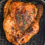 Overhead photo of air fryer whole chicken in air fryer basket. - 9