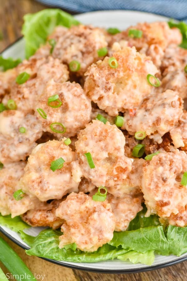 Overhead photo of bang bang shrimp served on a bed of lettuce.