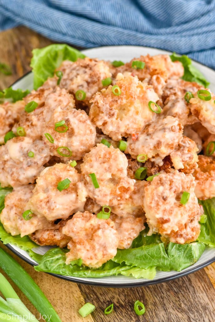 Overhead photo of bang bang shrimp served on a bed of lettuce.