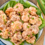 Overhead photo of bang bang shrimp served on a bed of lettuce. - 9