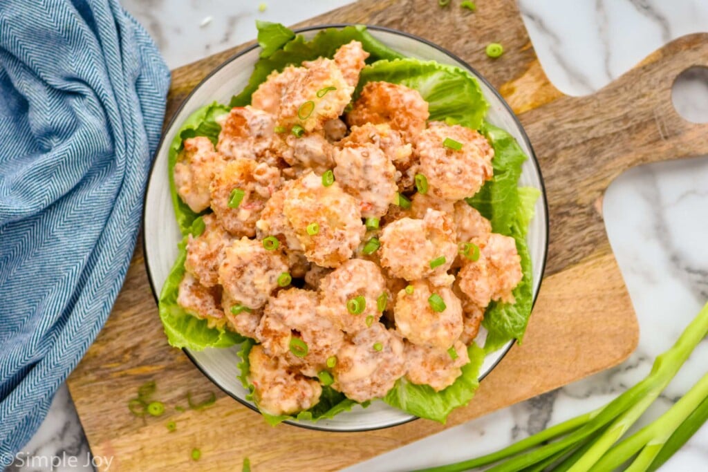 Overhead photo of bang bang shrimp served on a bed of lettuce.