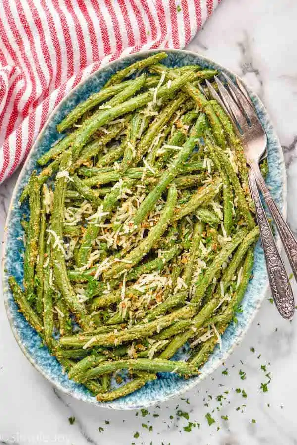 Overhead photo of Italian Green beans on a platter with forks for serving.