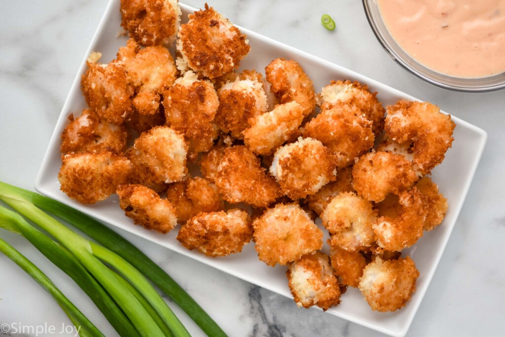 Overhead photo of cooked shrimp on plate for bang bang shrimp recipe.