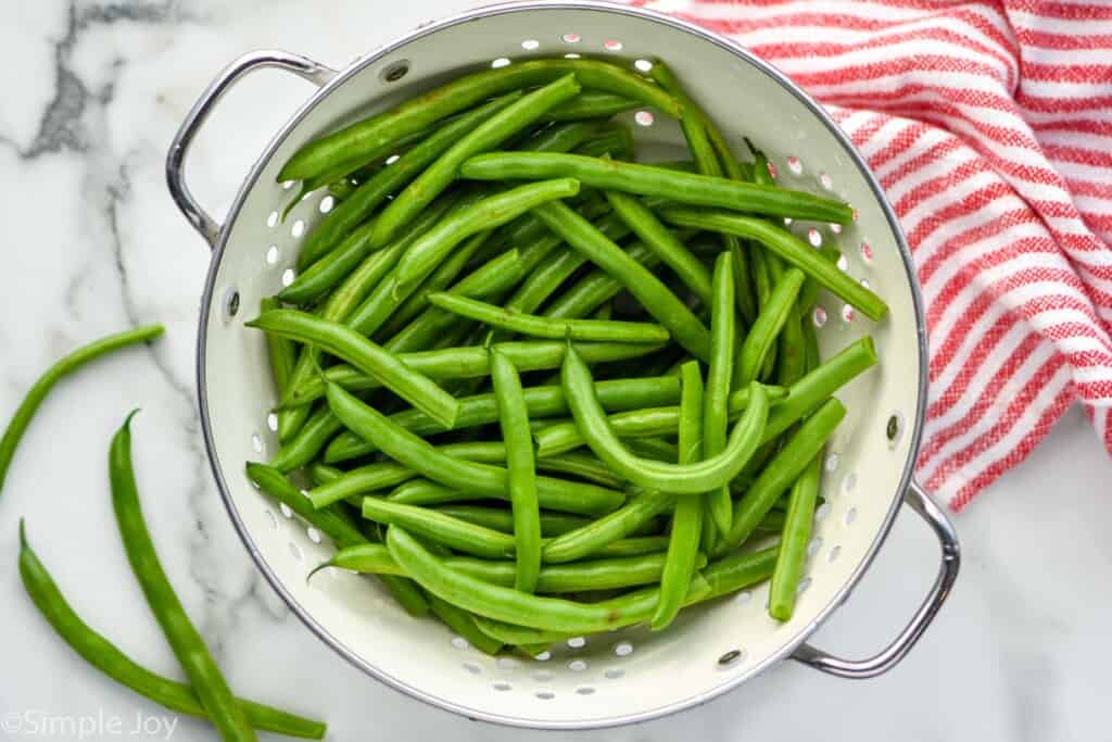 Overhead photo of green beans in a colander for italian green beans recipe.