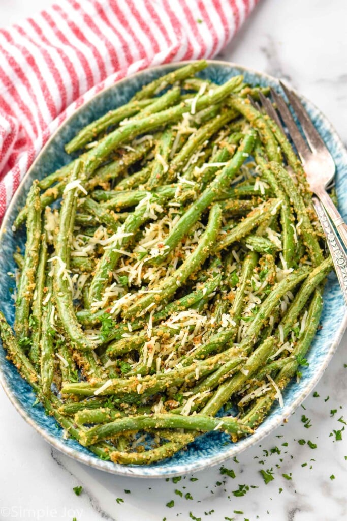 Overhead photo of Italian Green beans on a platter with forks for serving.