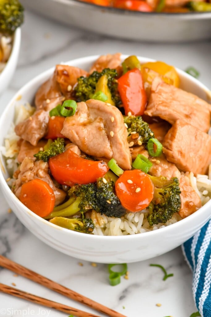 Overhead photo of pork stir fry served in a bowl with rice.