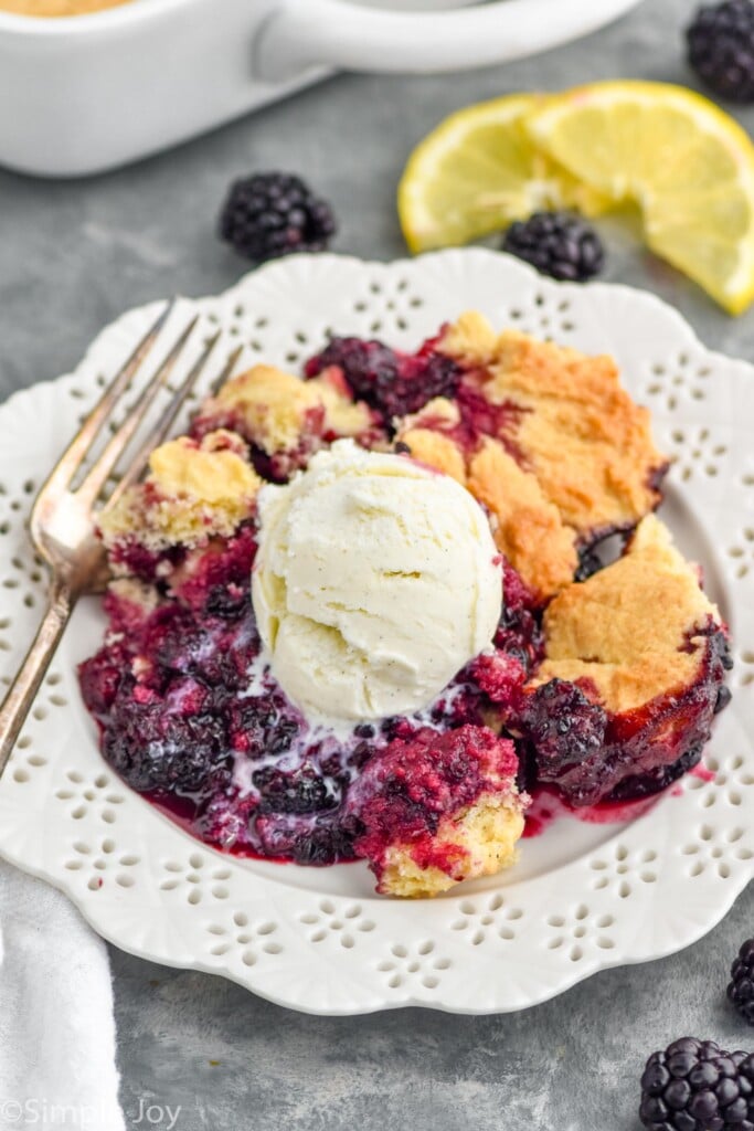 Overhead photo of blackberry cobbler recipe garnished with a scoop of ice cream.