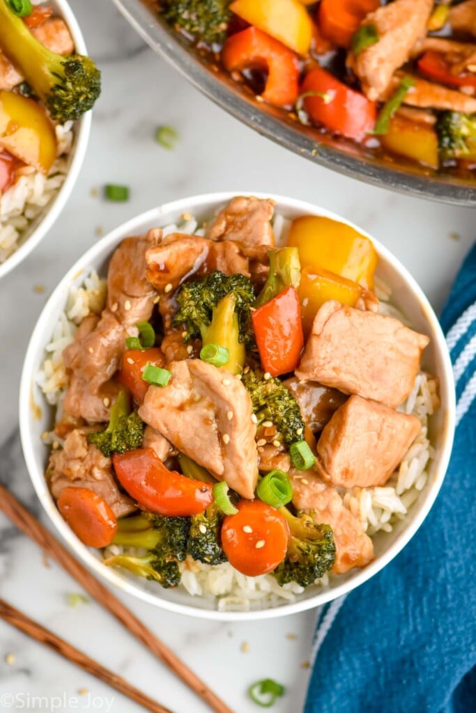 Overhead photo of pork stir fry served in a bowl with rice.