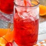 Pinterest graphic of Alabama Slammer recipe. Photo is a picture of man's hand pouring Alabama Slammer cocktail into a glass of ice. Orange slices and cherries sit beside the glass for garnish. Text says, "Refreshing Alabama Slammer simplejoy.com."