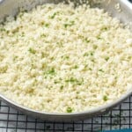 Pinterest graphic for cauliflower rice recipe. Image is overhead photo of cauliflower rice in a skillet. Text says, "cauliflower rice simplejoy.com"