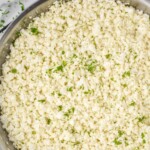 Pinterest graphic for cauliflower rice recipe. Text says, "the best cauliflower rice simplejoy.com." Image is overhead photo of cauliflower rice in a skillet.