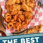 Pinterest graphic for chicken nuggets recipe. Image is overhead photo of a basket of chicken nuggets and curly fries. Ketchup for dipping on the side. Text says, "The best chicken nuggets simplejoy.com"