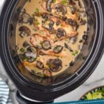 Pinterest graphic of Crock Pot Chicken Marsala recipe. Image is overhead photo of crock pot chicken marsala in a crockpot. Text says, "Crock Pot Chicken Marsala simplejoy.com"