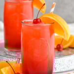Photo of Alabama Slammer cocktails served in a glass garnished with orange slice and a cherry. - 10