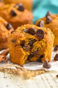 Photo of Pumpkin Chocolate Chip Muffins with a bite taken out.