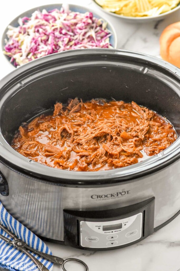 Overhead photo of Dr. Pepper Pulled Pork recipe in a crock pot.