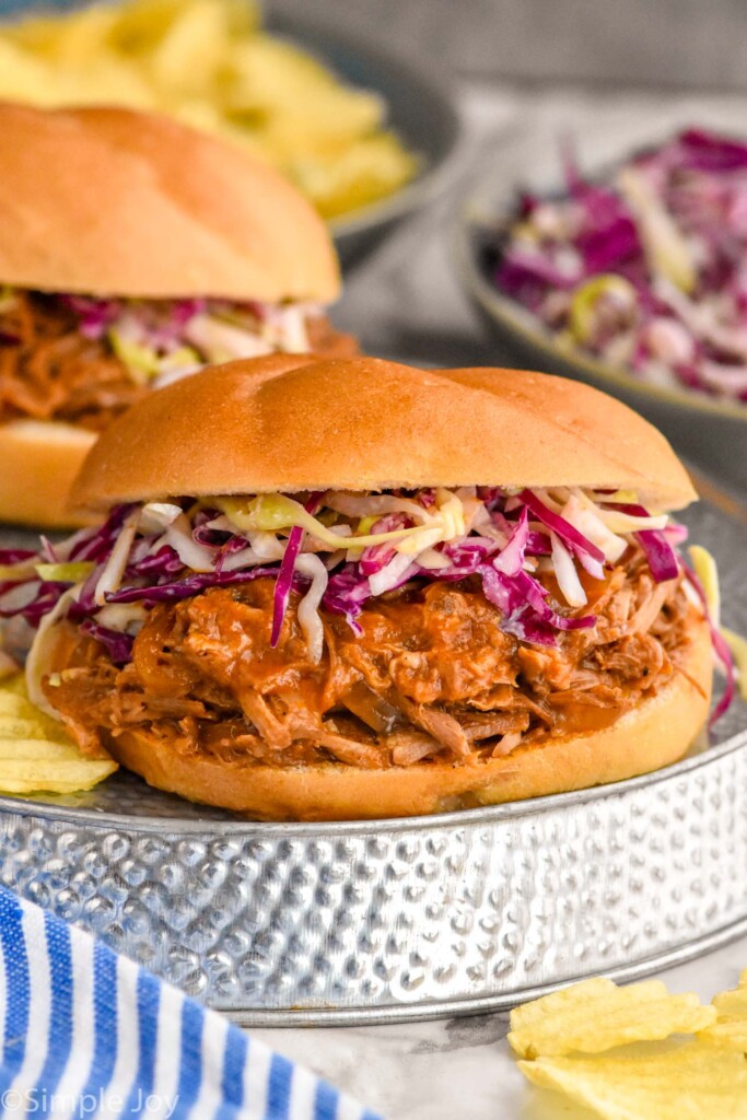 Photo of Dr. Pepper Pulled Pork sandwich garnished with slaw.