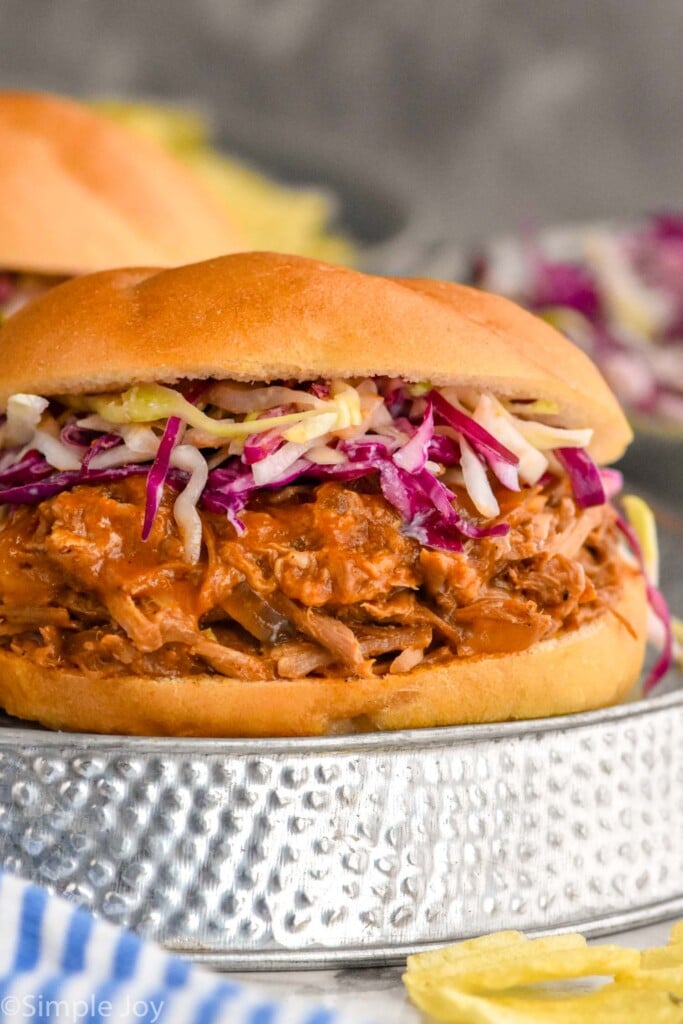 Photo of Dr. Pepper Pulled Pork sandwich garnished with slaw.