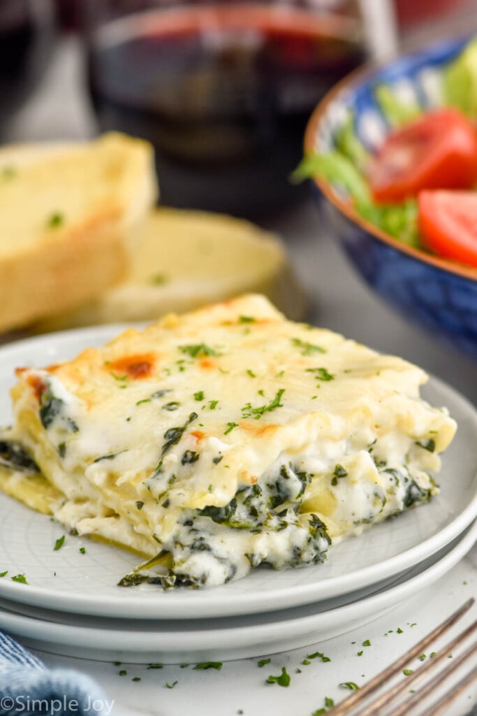 Photo of slice of Chicken Alfredo Lasagna on a plate.