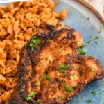 Pinterest graphic for Blackened Chicken recipe. Text says, "The Best Blackened Chicken simplejoy.com." Image is overhead photo of blackened chicken served on a plate with rice.