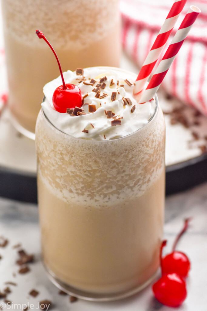 glass of bushwhacker, topped with whipped cream, cherries, and chocolate shavings