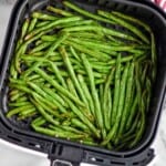 Overhead photo of Air Fryer Green Beans in an air fryer basket. - 7