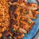 Overhead photo of Blackened Chicken sliced and served on a plate with rice.