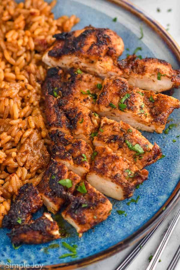 Overhead photo of Blackened Chicken sliced and served on a plate with rice.