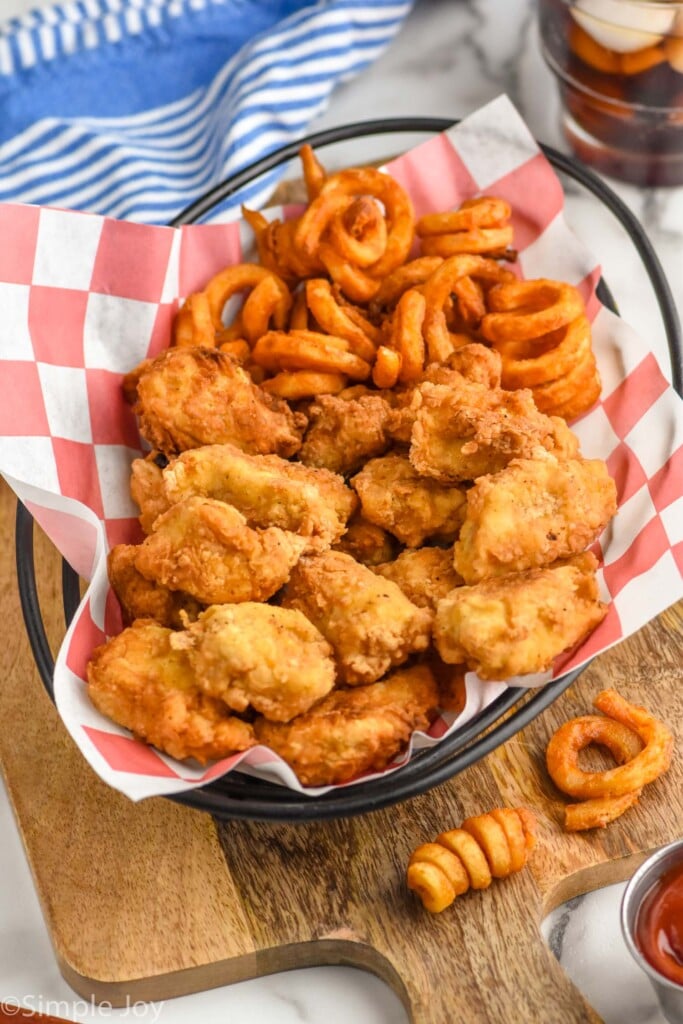 a basket of homemade chicken nuggets with curly fries