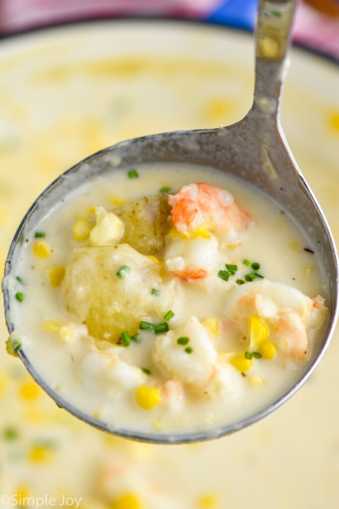 Overhead photo of a ladle full of Shrimp and Corn Chowder.