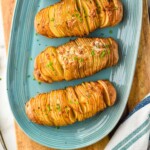 pinterest graphic for hasselback potatoes. Text says "amazing hasselback potatoes simplejoy.com" Image shows overhead of hasselback potatoes on a plate for serving.