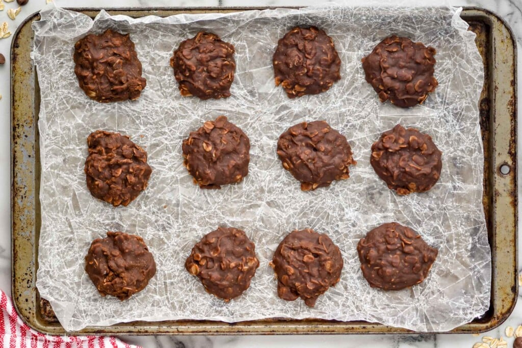 Overhead photo of No Bake Chocolate Oatmeal Cookies on a baking sheet with wax paper.