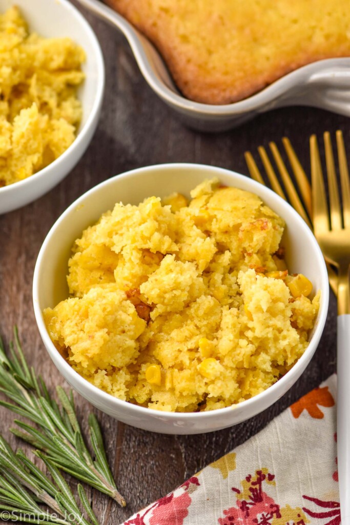 Overhead photo of Corn Casserole in a bowl with forks for eating.