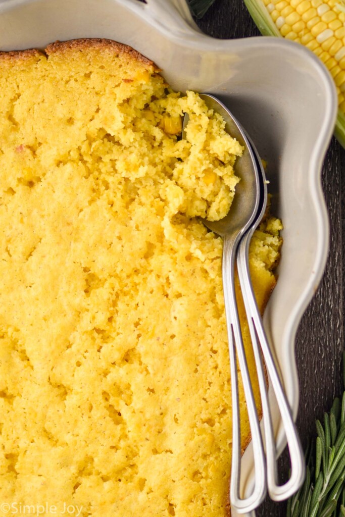 Overhead photo of Corn Casserole with spoons for serving.