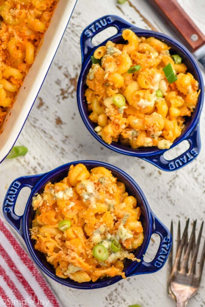 Overhead photo of bowls of Buffalo Chicken Mac and Cheese with forks for eating.