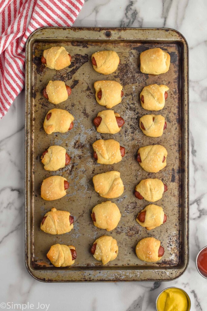 overhead of pigs in a blanket on a baking sheet