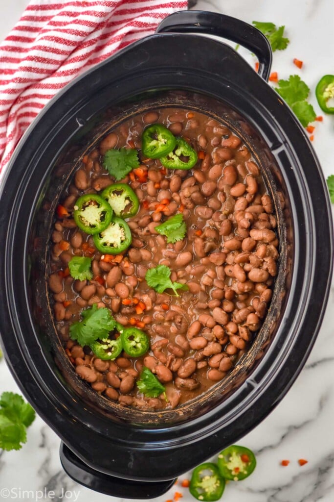overhead of pinto beans in a the crock pot after cooking