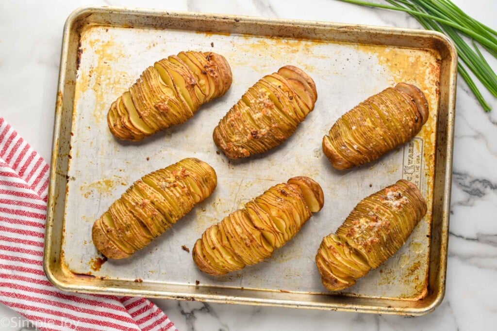 overhead of hasselback potatoes on a baking sheet