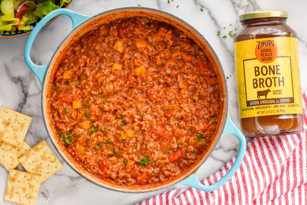 overhead of a pot of stuffed pepper soup with a jar of zoup bone beef broth next to it