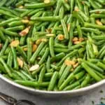 pinterest graphic of skillet with green bean almondine recipe, says: "green beans almondine, simplejoy.com"