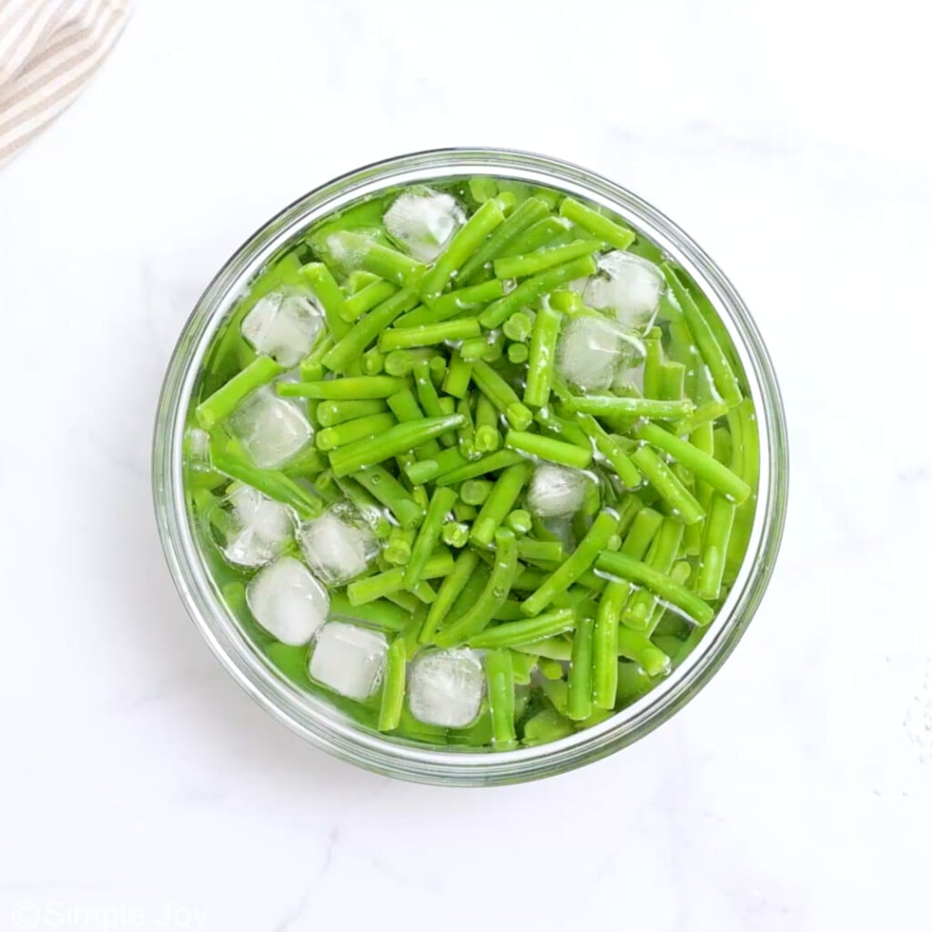 overhead of a bowl of ice water with green beans - 5