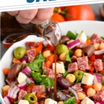 Pinterest photo of Overhead photo of Italian Chopped Salad in a white bowl with dressing being poured out of a glass pitcher, says 'amazing Italian chopped salad simplejoy.com'