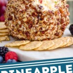 pinterest graphic for pineapple cheese ball. Text says "pineapple cheese ball simplejoy.com" Image shows pineapple cheese ball surrounded by crackers and fresh berries.